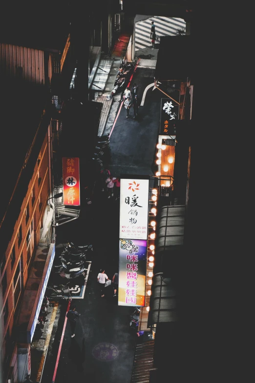 an overhead view of a city street at night, a picture, unsplash contest winner, ukiyo-e, dilapidated neon signs, ✨🕌🌙, instagram story, on black background