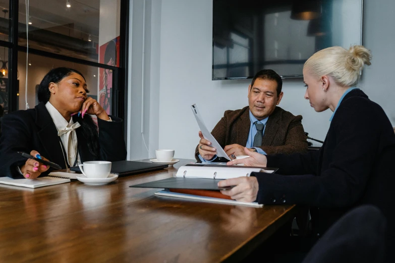 a group of people sitting around a wooden table, profile image, professional image, thumbnail