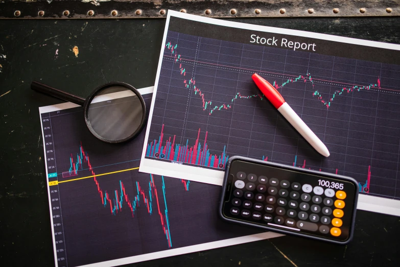 a close up of a calculator, a pen, and a magnifying glass on a table, a picture, by Andries Stock, pexels, analytical art, waveforms on top of square chart, trading stocks, high quality product image”, a handsome