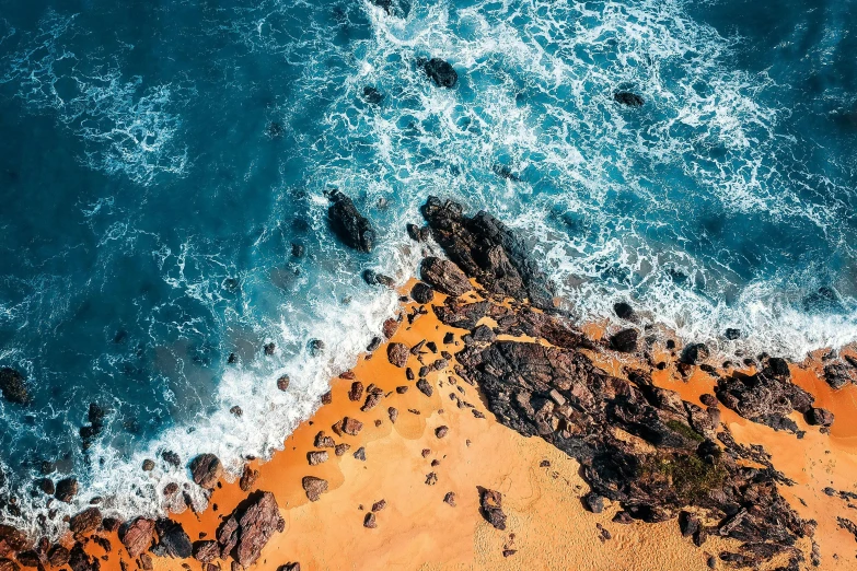 an aerial view of a beach with rocks and water, pexels contest winner, blue and orange, profile image, thumbnail, tropical ocean