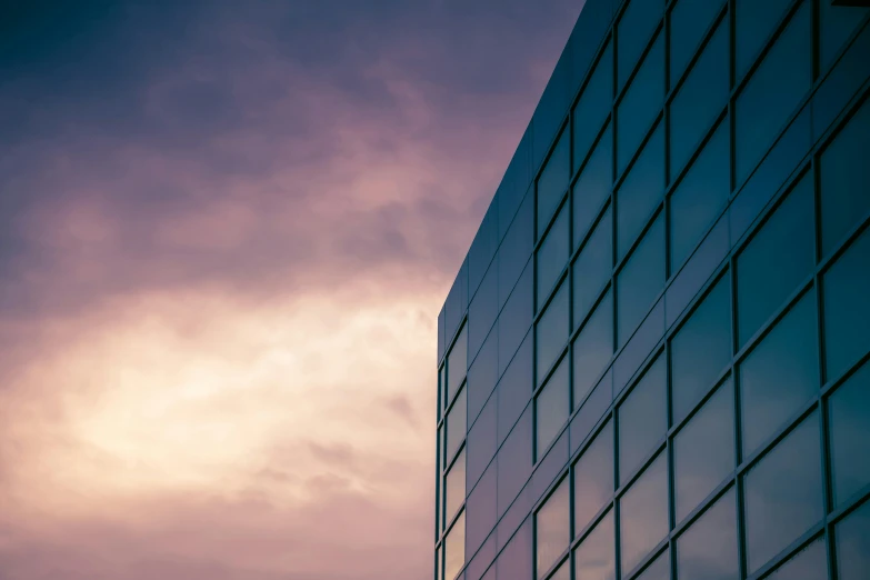a plane is flying in front of a building, inspired by Richard Wilson, unsplash, modernism, purple sky, square shapes, glass wall, thumbnail