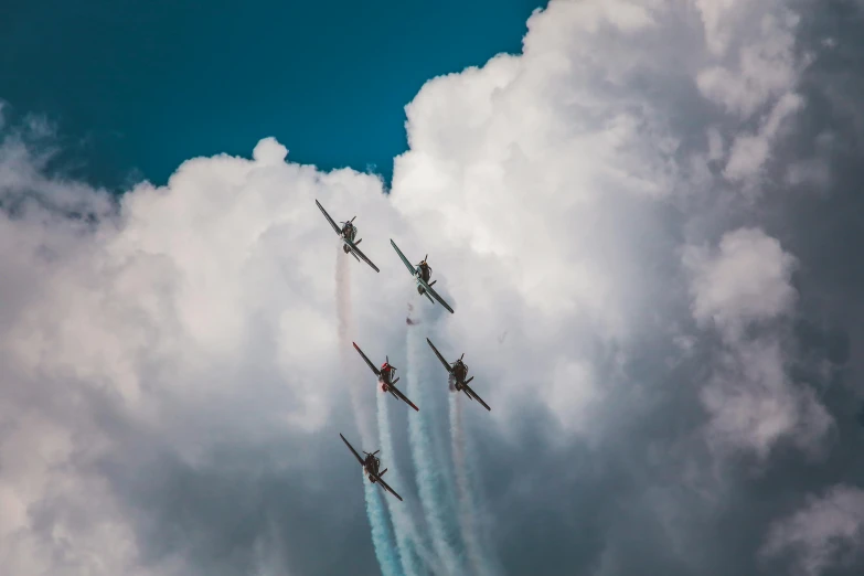 a group of fighter jets flying through a cloudy sky, by Matthias Stom, pexels contest winner, figuration libre, biplanes, light blue sky with clouds, concert photo, thumbnail