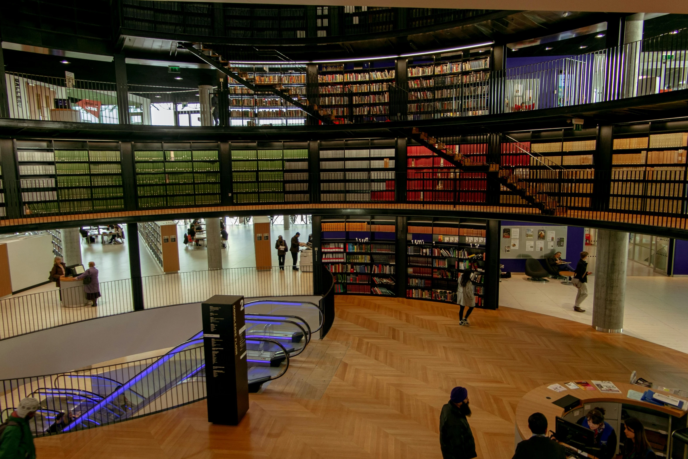 a large library filled with lots of books, by Hugo van der Goes, displayed in the exhibition hall, purple, rotunda, video