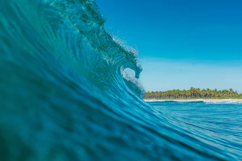 a man riding a wave on top of a surfboard, by Peter Churcher, unsplash contest winner, sumatraism, tones of blue and green, glassy fracture, closeup - view, slide show