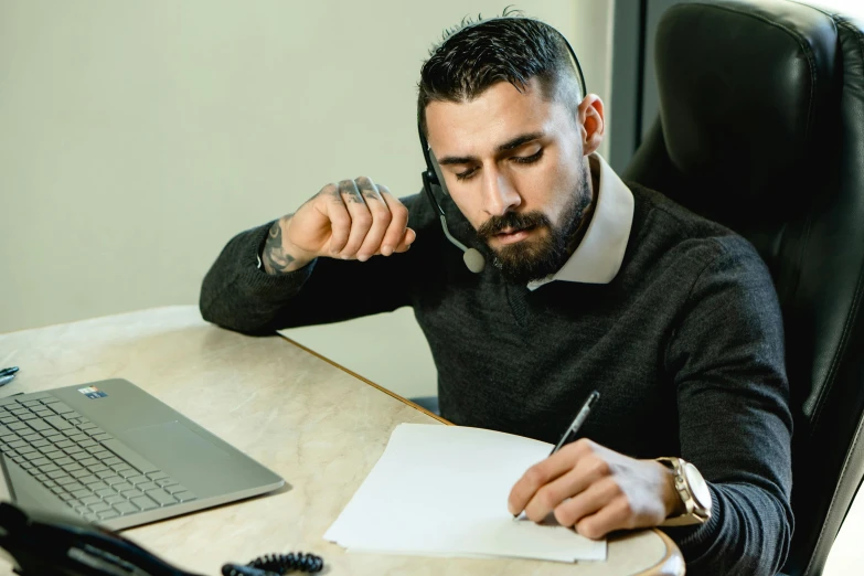 a man sitting at a desk in front of a laptop, pexels contest winner, hurufiyya, working in a call center, pen and paper, 1 4 9 3, thumbnail