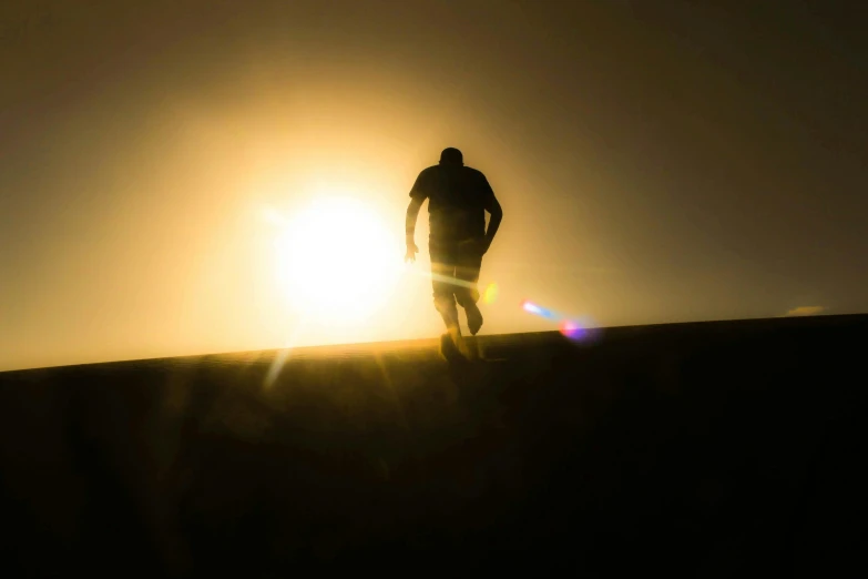 a silhouette of a man standing on top of a hill, by Eglon van der Neer, pexels contest winner, happening, photo of boris johnson running, sun glare, 10k, warm weather