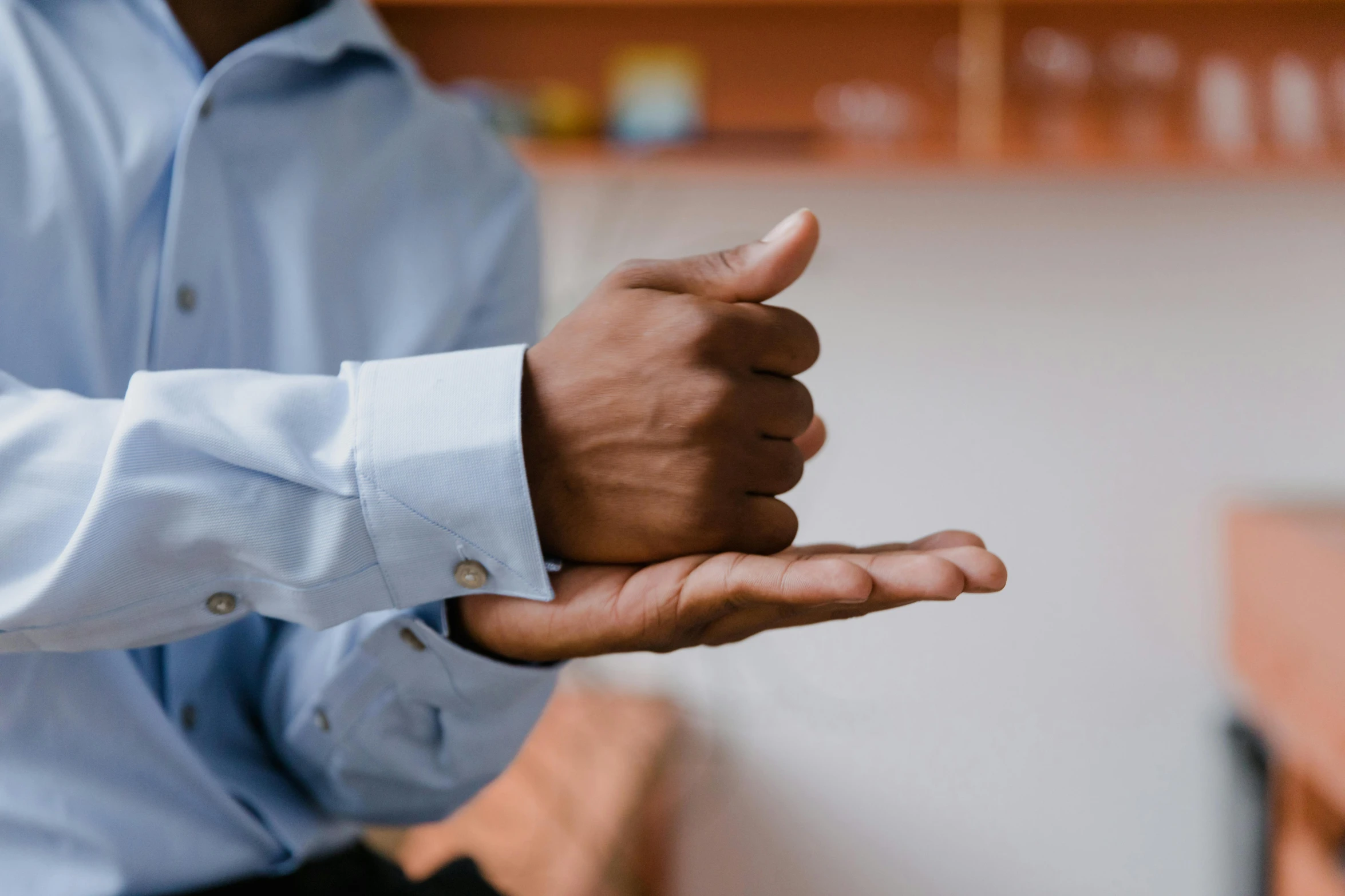 a close up of a person holding something in their hand, relaxed posture, wearing a shirt, multiple stories, healthcare