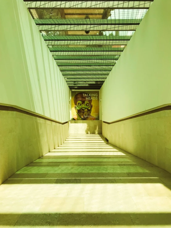 a long hallway with a painting on the wall, an album cover, inspired by Rodolfo Escalera, trending on unsplash, berlin secession, walking down a marble stairwell, in a mall, sunny day time, 2 0 0 0's photo