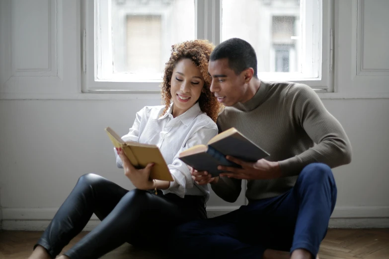 a man and woman sitting on the floor reading a book, pexels contest winner, renaissance, mixed race, holding books, avatar image, profile picture