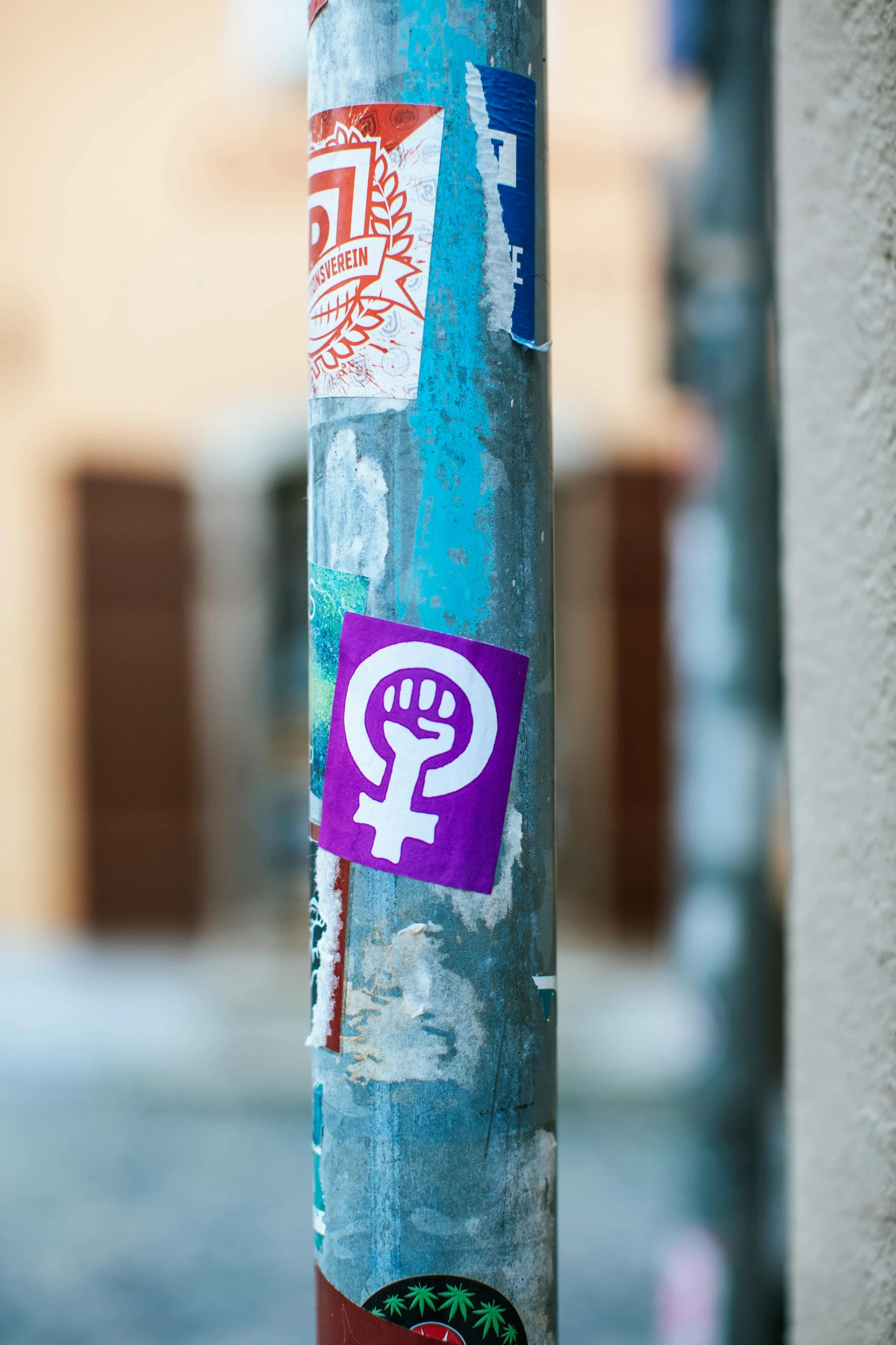 a pole with a bunch of stickers on it, trending on pexels, feminist art, ((purple)), square, european, high-resolution