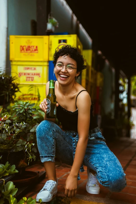 a woman sitting on the ground with a bottle of beer, pexels contest winner, jakarta, smiling confidently, avatar image, mixed-race woman