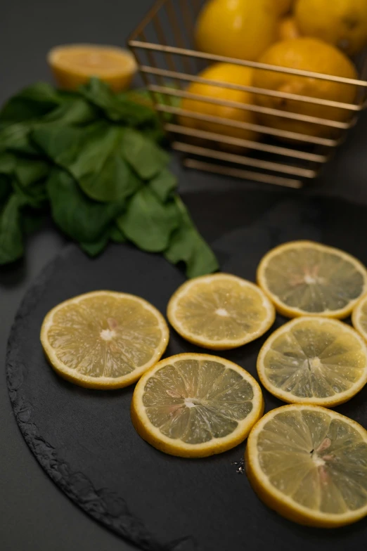 a bunch of lemons sitting on top of a cutting board, slate, sleek round shapes, caparisons, mint