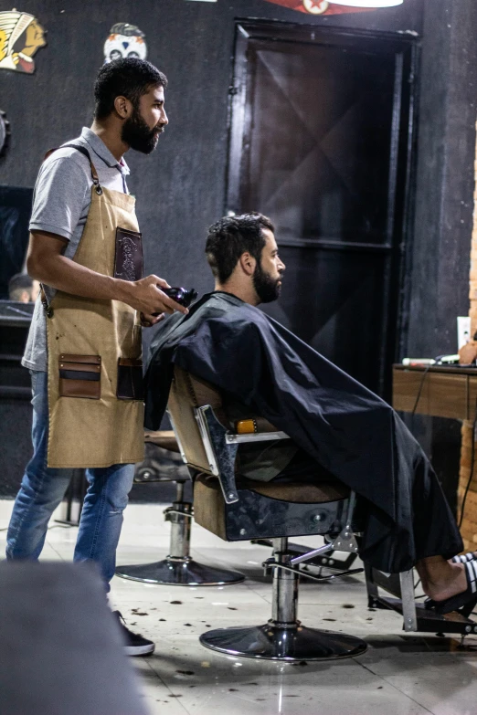 a man getting a haircut at a barber shop, by Ahmed Yacoubi, pexels contest winner, full growth from the back, cairo, tech robes, ( ( theatrical ) )