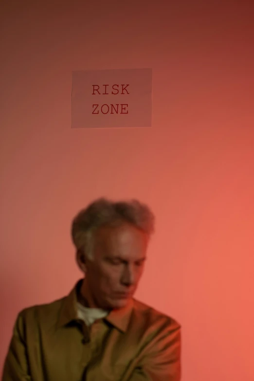 a man standing in front of a red wall, an album cover, flickr, conceptual art, worksafe. cinematic, midnight zone, nick knight, looking serious