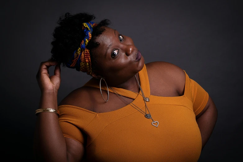 a woman in a yellow top posing for a picture, an album cover, by Winona Nelson, pexels contest winner, plus size, ( ( brown skin ) ), portrait 8 k, promotional image