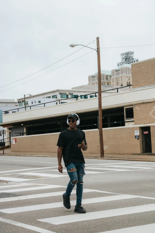 a man riding a skateboard across a street, by Washington Allston, trending on unsplash, visual art, wearing black headphones, beautiful city black woman only, cleveland, standing on street corner