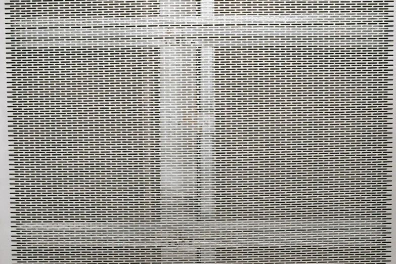 a black and white photo of a cross on a wall, inspired by Andreas Gursky, perforated metal, detail, courtesy of moma, cages