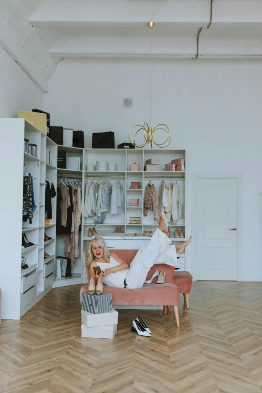 a woman sitting on a couch in a room, elegant wardrobe, official store photo, anna nikonova aka newmilky, panorama