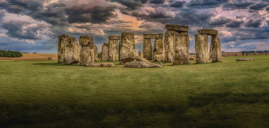 a group of stones sitting on top of a lush green field, by Joseph Henderson, pexels contest winner, renaissance, gigantic pillars, panoramic photography, magic portal in the sky, preserved historical