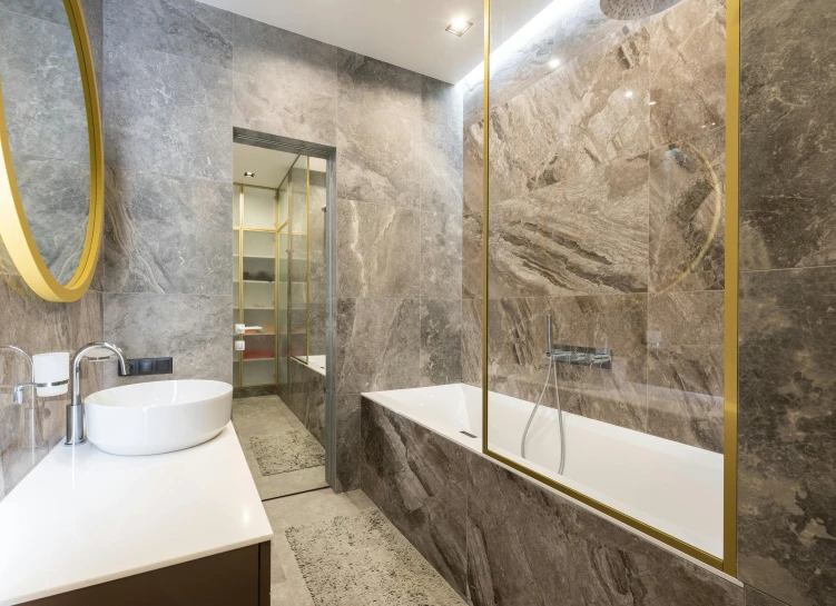 a bath room with a sink a mirror and a bath tub, pexels contest winner, stone and glass and gold, panels, bronze, stainless steal