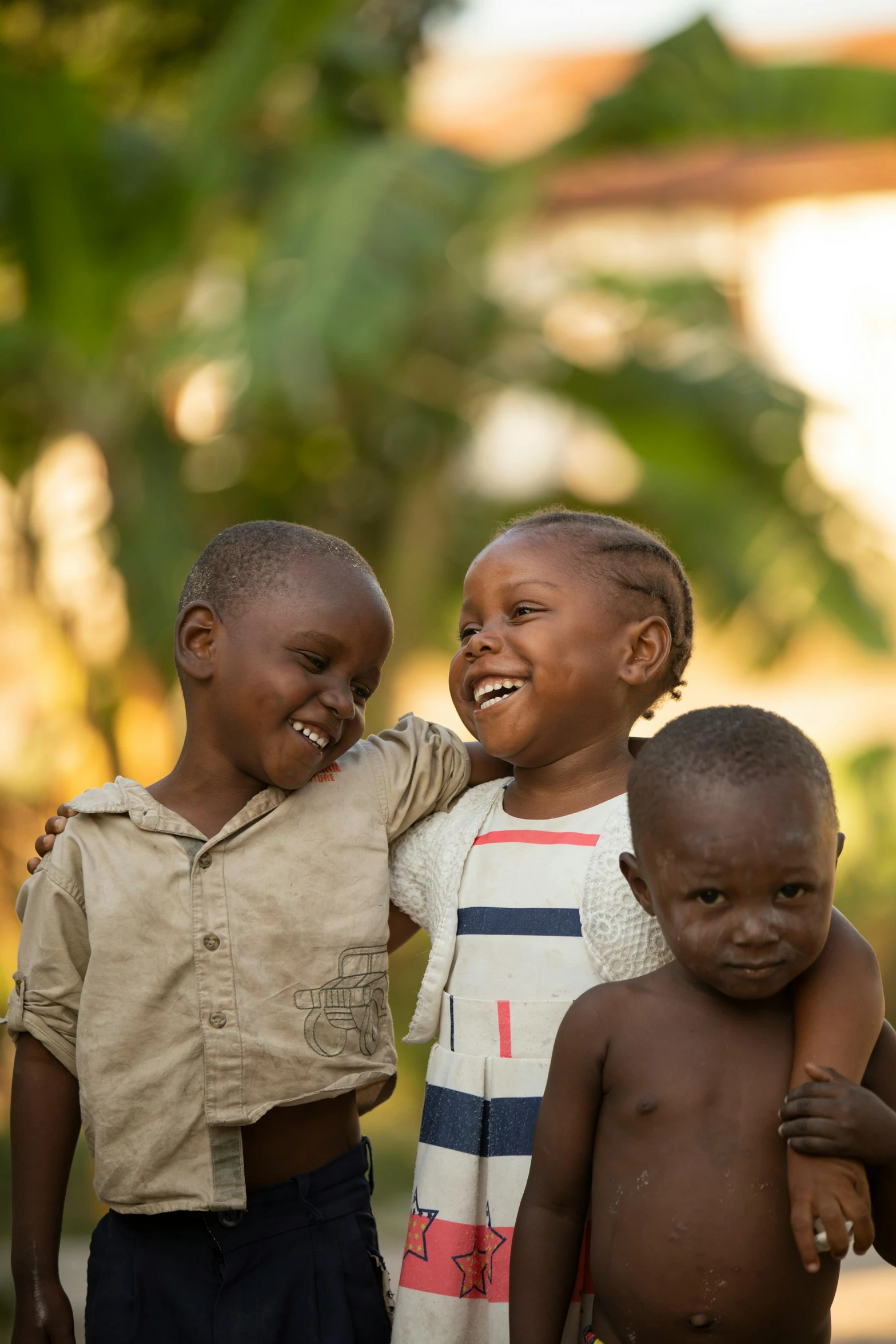 a group of children standing next to each other, by Ingrida Kadaka, smiling laughing, late afternoon, slide show, sweet hugs