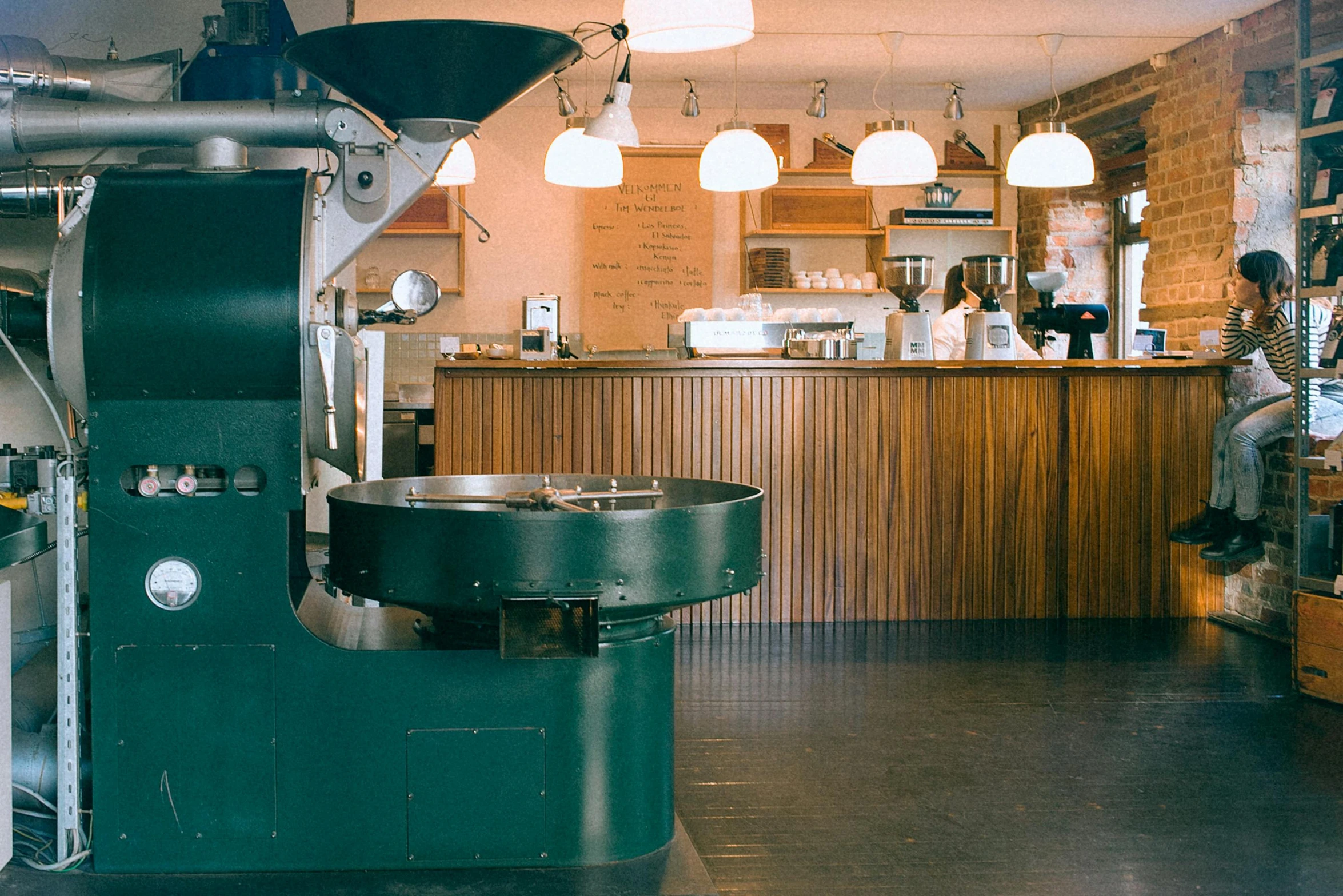 a machine that is sitting inside of a building, by Yasushi Sugiyama, trending on unsplash, celebration of coffee products, 1960s color photograph, woodfired, a green