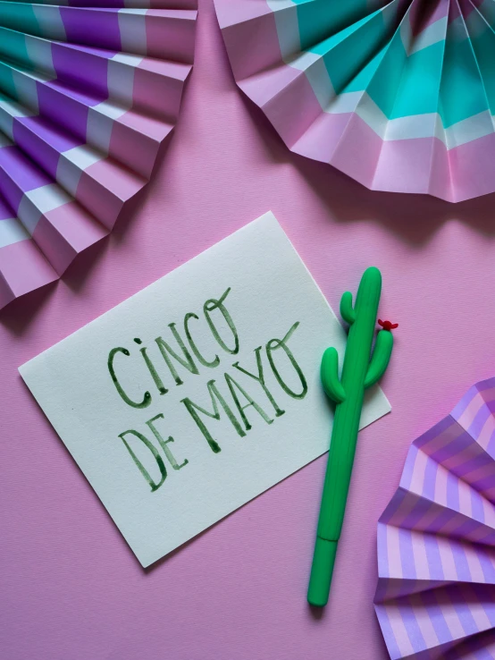 a piece of paper with the words cinco de mayo written on it, inspired by Germán Londoño, pexels contest winner, calatrava, pink, greeting card, product shot