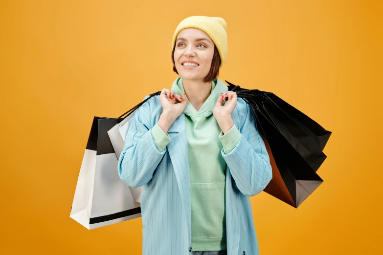 a woman holding shopping bags and smiling at the camera, trending on pexels, maximalism, wearing a yellow hoodie, avatar image, thumbnail, exasperated