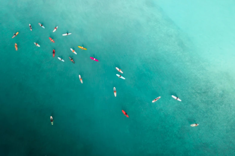 a group of people riding surfboards on top of a body of water, a tilt shift photo, by Adam Marczyński, pexels contest winner, teal silver red, small canoes, looking down from above, a colorful