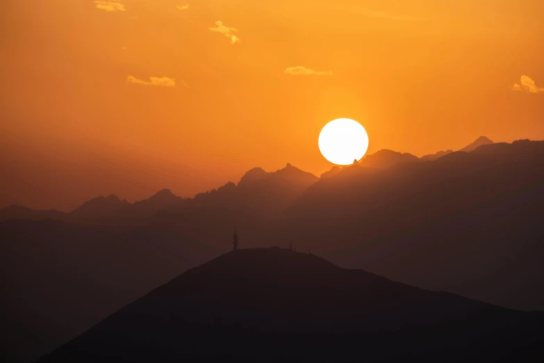 a person standing on top of a mountain at sunset, by Tobias Stimmer, pexels contest winner, gigantic sun, telephoto, nanquan, fine art print
