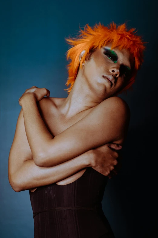 a woman with orange hair posing for a picture, an album cover, inspired by Bert Stern, trending on pexels, androgyny, iridescent skin, dark. studio lighting, orange skin
