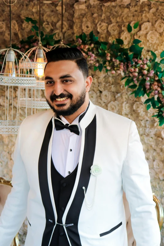 a man and a woman standing next to each other, featured on reddit, hurufiyya, wearing a white tuxedo, portrait photo of a backdrop, arab man light beard, profile image