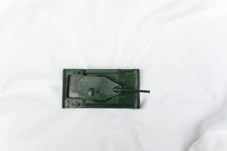 a close up of a mouse on a bed, by Attila Meszlenyi, figuration libre, tank class, photograph from above, plastic, green