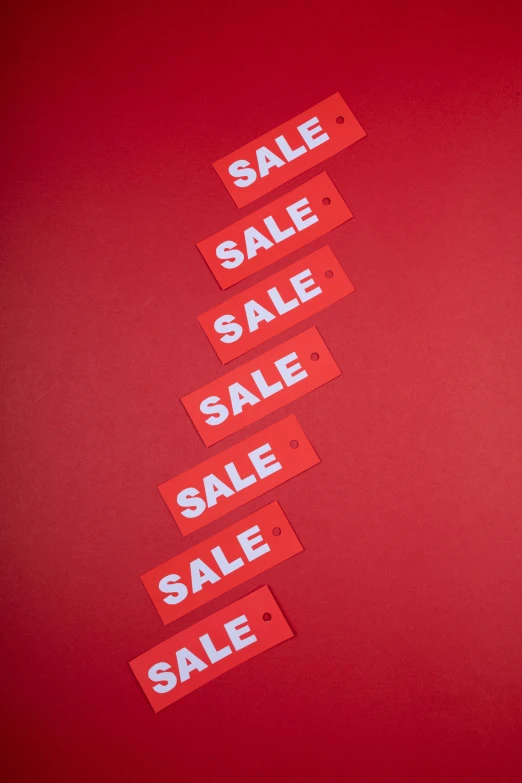 a pile of sale tags on a red background, trending on unsplash, tall shot, - 8, panels, aerial