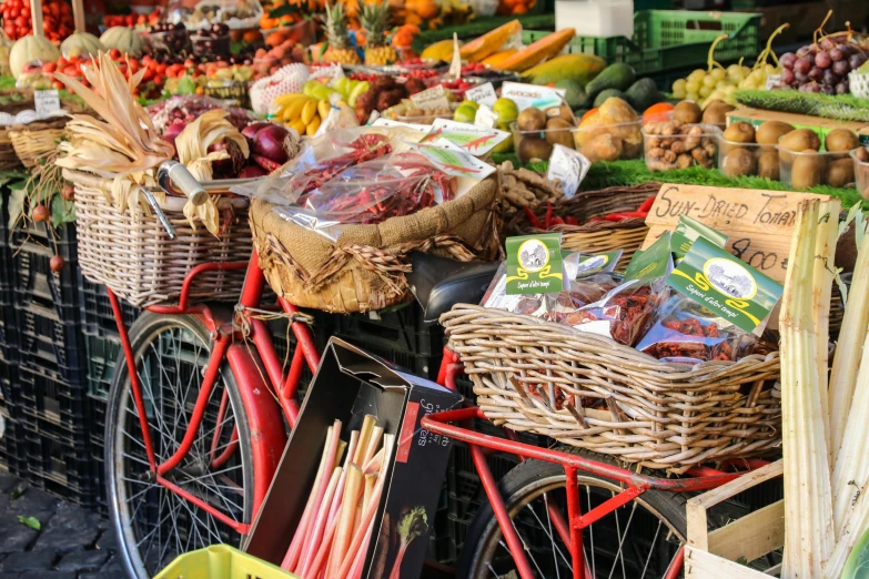 a bicycle parked in front of a fruit stand, market stalls, vibrant red and green colours, overflowing feast buffet table, 🦩🪐🐞👩🏻🦳