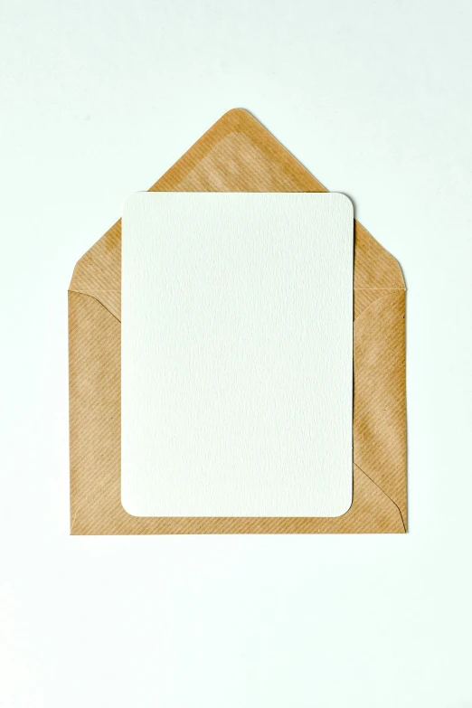 a white card sitting on top of a brown envelope, no text, product image, multiple stories, white borders