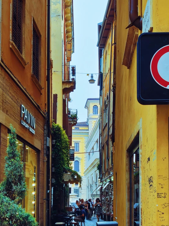 a no parking sign hanging from the side of a building, a photo, pexels contest winner, all roads lead to rome, yellow walls, indigo! and venetian red!, profile image