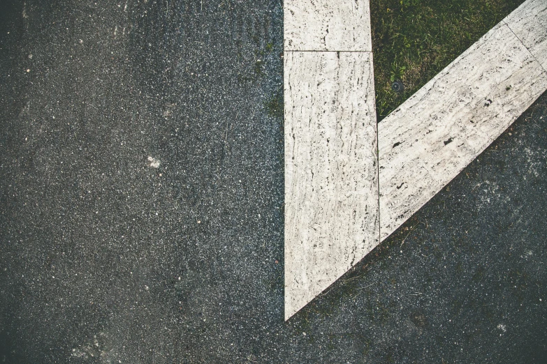 a white arrow painted on the side of a road, an album cover, by Attila Meszlenyi, unsplash, concrete art, game texture, square lines, alessio albi, variety of shapes and textures