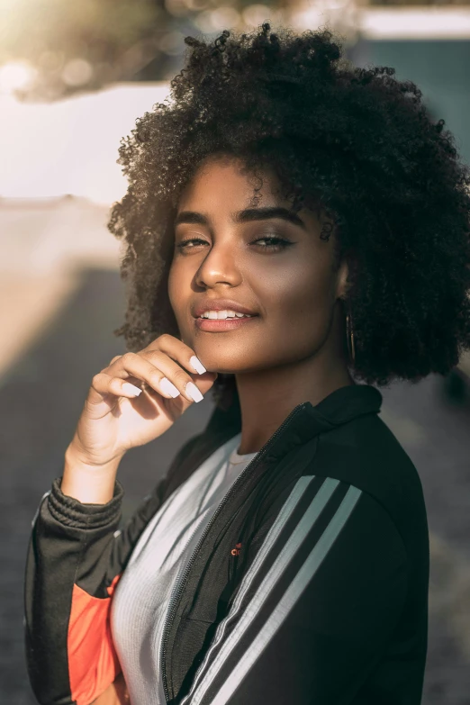 a woman standing on the side of a road talking on a cell phone, an album cover, by Nadir Afonso, pexels contest winner, renaissance, dark short curly hair smiling, imaan hammam, closeup headshot, perfect crisp sunlight