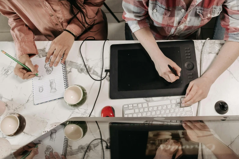 a couple of people that are sitting at a table, a drawing, trending on pexels, computer art, a high angle shot, creative coder with a computer, close up to the screen, maintenance photo