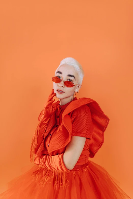 a woman wearing an orange dress and sunglasses, by Winona Nelson, trending on pexels, rococo, girl with short white hair, charli xcx, monochromatic red, hearts