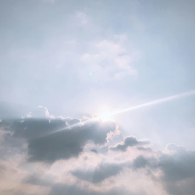 a large jetliner flying through a cloudy sky, a picture, pexels contest winner, light and space, large sun in sky, soft light.4k, pearly sky, holy halo