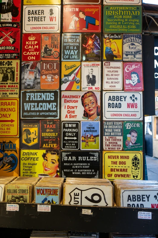 a bunch of signs that are on a wall, by Chippy, pop art, the british museum, beautiful labels, barrels, 1 9 5 0's decor