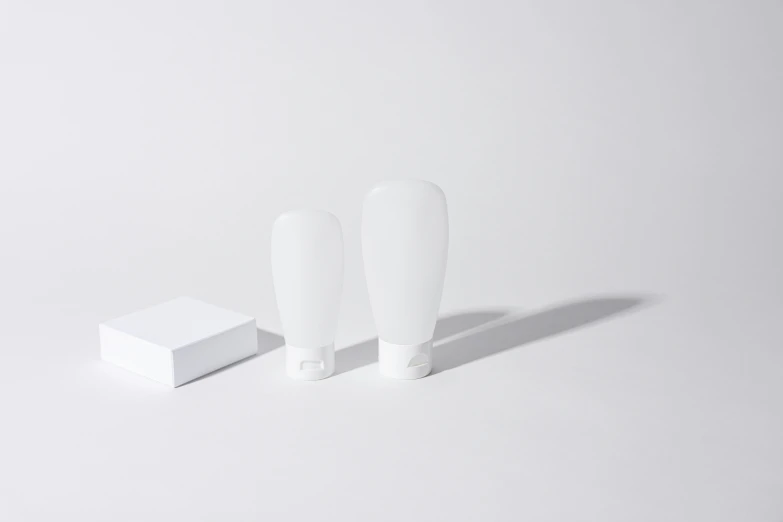 a couple of toothbrushes sitting next to a box of toothpaste, an ambient occlusion render, by Daniel Gelon, unsplash, minimalism, lamps, product introduction photo, vinyl designer toy, matte white background