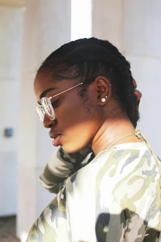 a close up of a person on a cell phone, an album cover, by Richmond Barthé, trending on pexels, long braided hair pulled back, wearing shades, profile view, iu