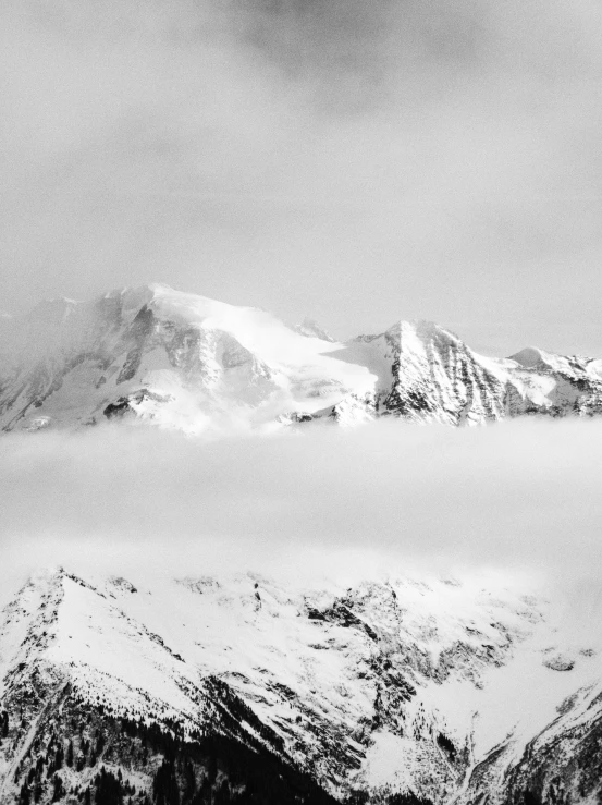 a black and white photo of snow covered mountains, a black and white photo, by Cedric Peyravernay, fine art, upon the clouds, today\'s featured photograph 4k, jovana rikalo, panorama