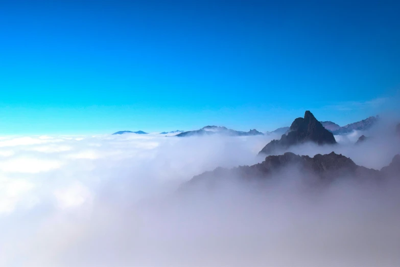 a group of people standing on top of a mountain, by Peter Churcher, pexels contest winner, romanticism, through clouds blue sky, chile, panorama view of the sky, floating in mist