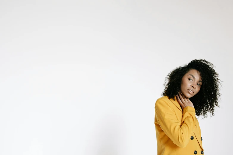 a woman in a yellow jacket posing for a picture, trending on pexels, curls, animation, portrait image, banner