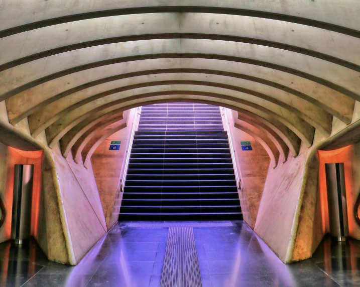 an escalator and some stairs in a building, an album cover, inspired by Zaha Hadid, pexels contest winner, art nouveau, orange and purple color scheme, concrete, inside of a metro train, costa blanca