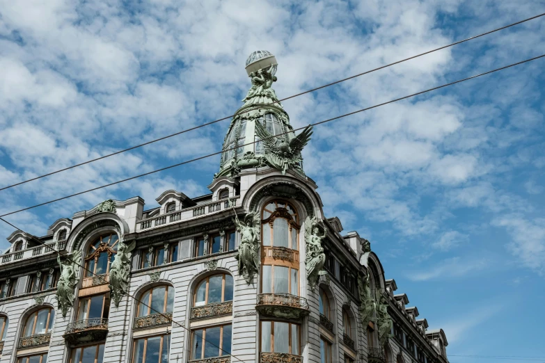 a building with a statue on top of it, inspired by Cornelis Engebrechtsz, pexels contest winner, art nouveau, shops, olafur eliasson, brown, grey